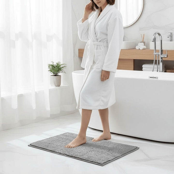 Chenille bath mat with a non-slip backing on a bathroom floor - product photo 2