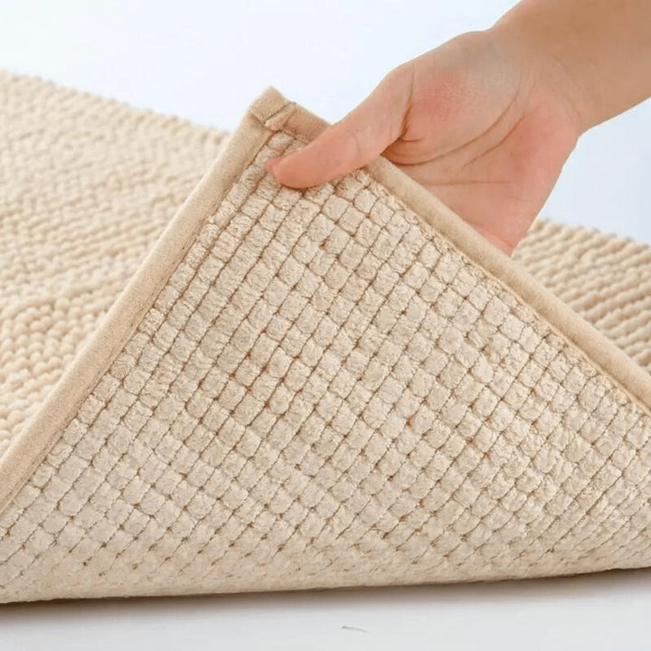 Chenille bath mat with a non-slip backing on a bathroom floor - product photo 7