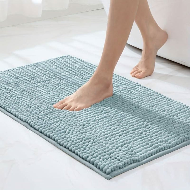 Chenille bath mat with a non-slip backing on a bathroom floor - product photo 9