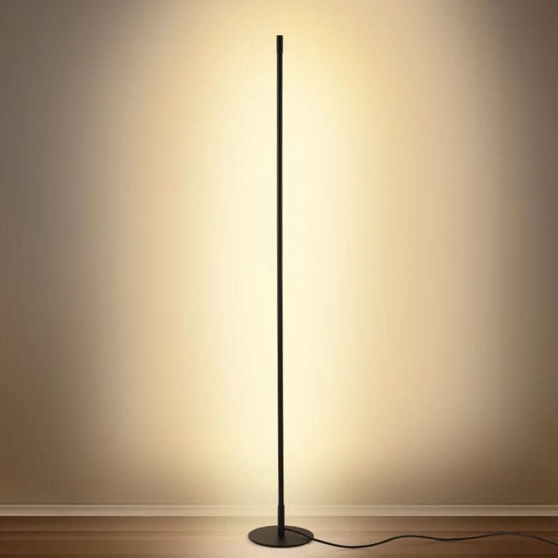 Slim metal LED floor lamp beside a reading chair - product photo 2