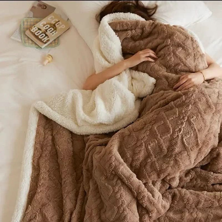 Double-sided sherpa and flannel blanket folded on a bed - product photo 1