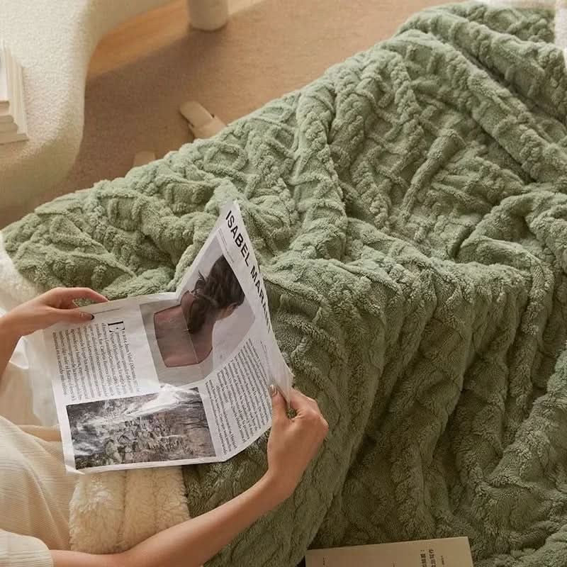 Double-sided sherpa and flannel blanket folded on a bed - product photo 2