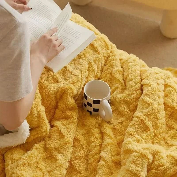 Double-sided sherpa and flannel blanket folded on a bed - product photo 3
