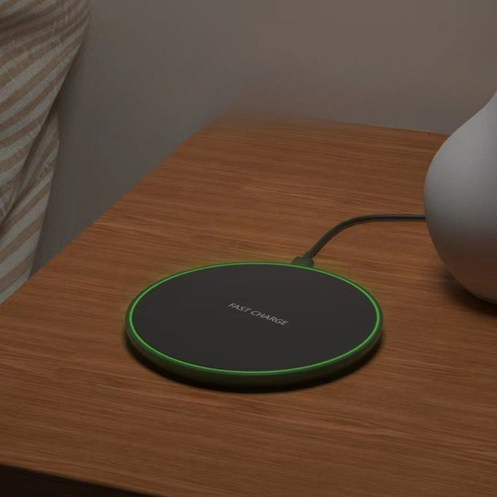 Wireless charging pad with a phone on it - product photo 5