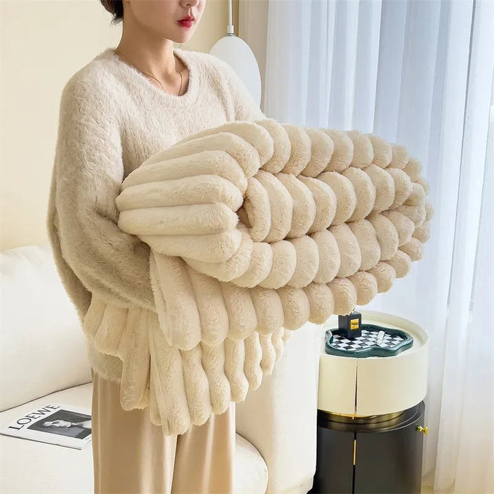 Faux fur throw blanket draped over a sofa - product photo 1