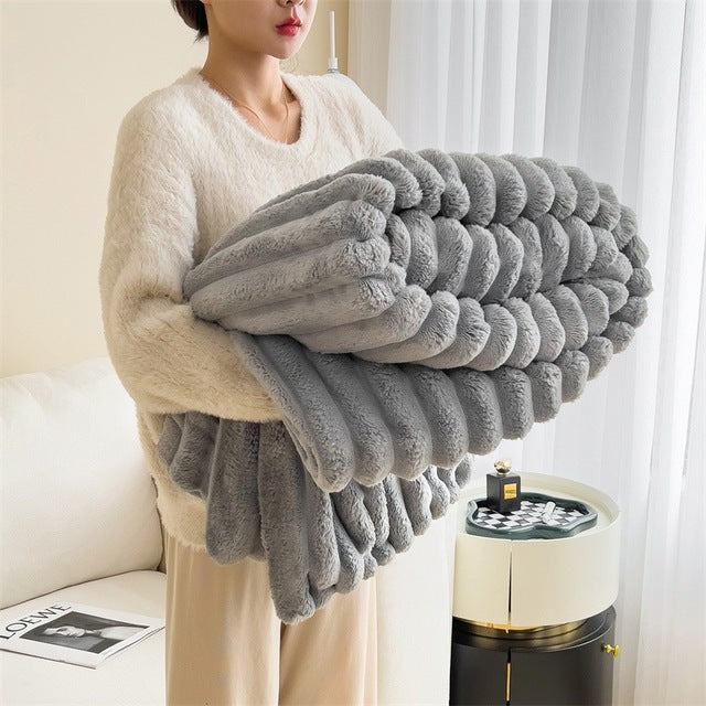 Faux fur throw blanket draped over a sofa - product photo 2
