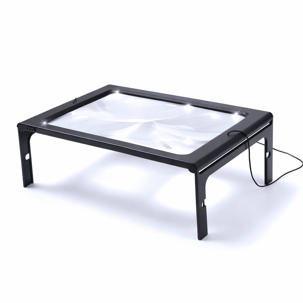 Foldable page magnifier with LED lighting standing over a book - product photo 5