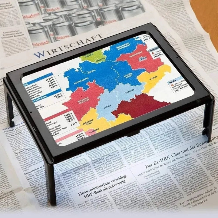 Foldable page magnifier with LED lighting standing over a book - product photo 6