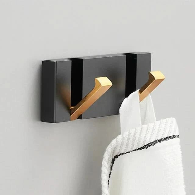Foldable aluminum wall hooks folded flat against their rail - product photo 1