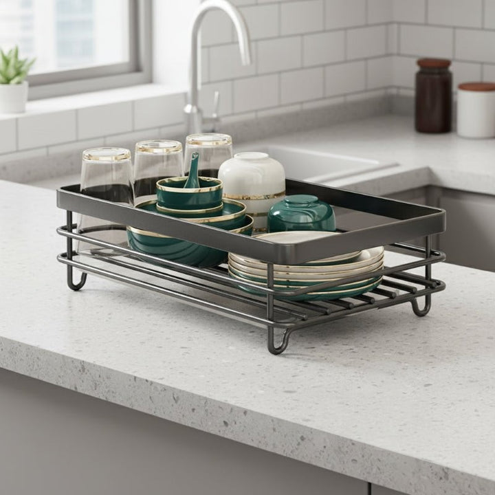 Foldable stainless steel dish drying rack beside a sink - product photo 1