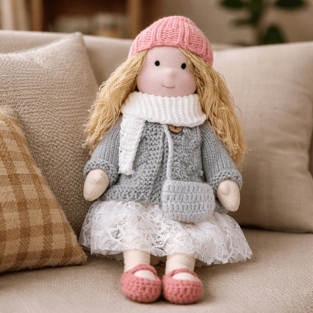 Handmade Waldorf-style cotton doll with a pink knit hat, white scarf, gray coat and a lace skirt