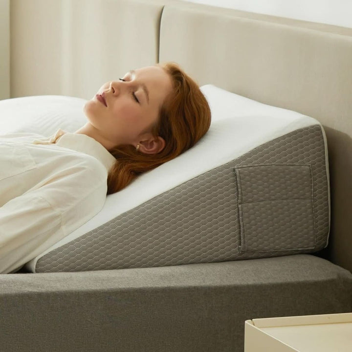 Inclined foam wedge pillow on a bed - product photo 1