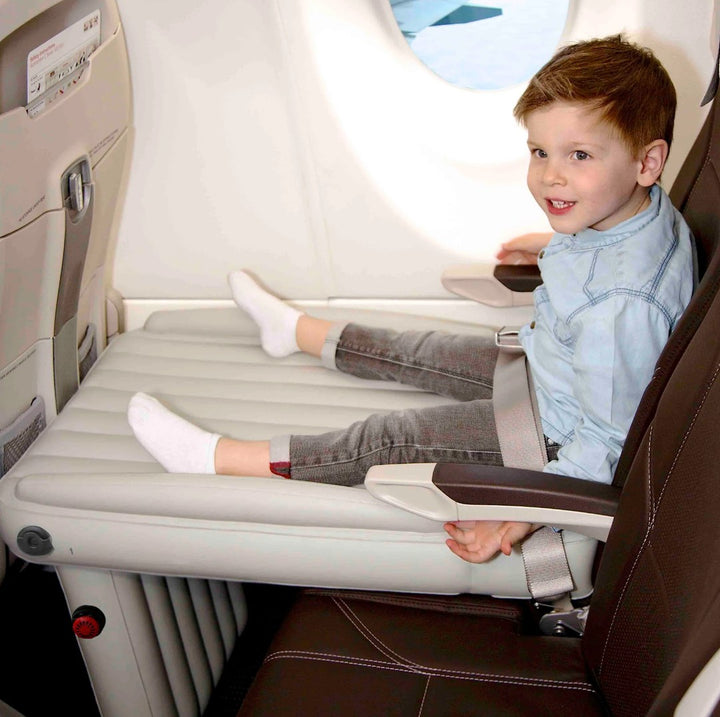 Inflatable airplane footrest bed set up in a seat - product photo 1