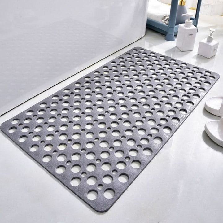 Non-slip shower mat with suction cups and drainage holes in a bathtub - product photo 1