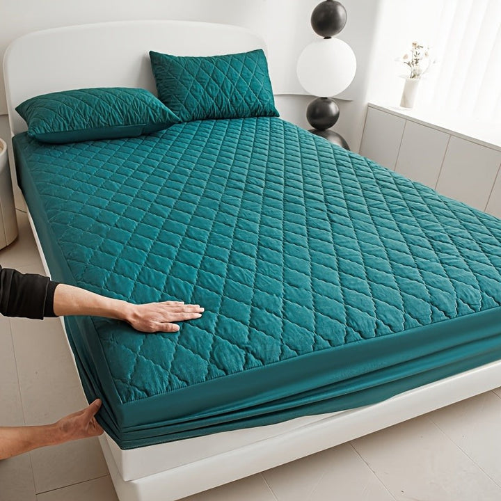 Quilted waterproof mattress protector on a bed - product photo 1