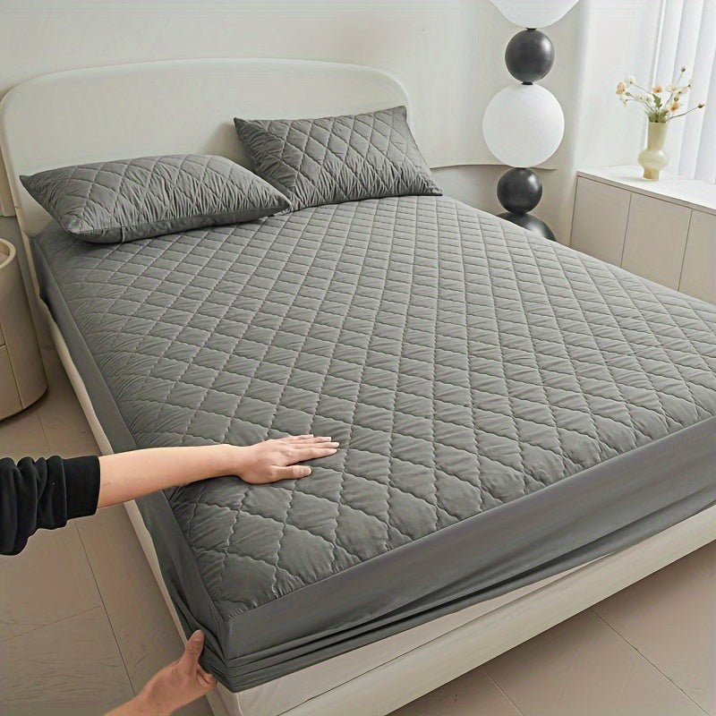 Quilted waterproof mattress protector on a bed - product photo 2
