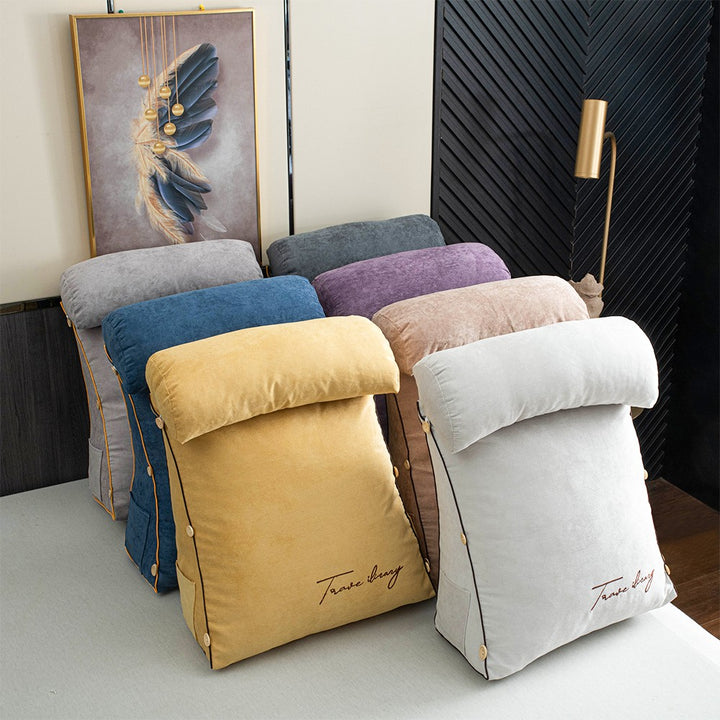 Reading cushion with arms and a side pocket on a bed - product photo 1
