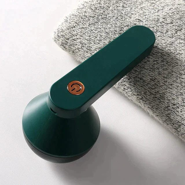 Rechargeable fabric shaver removing pills from a sweater - product photo 1