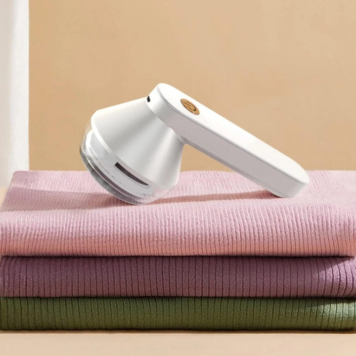 Rechargeable fabric shaver removing pills from a sweater - product photo 3