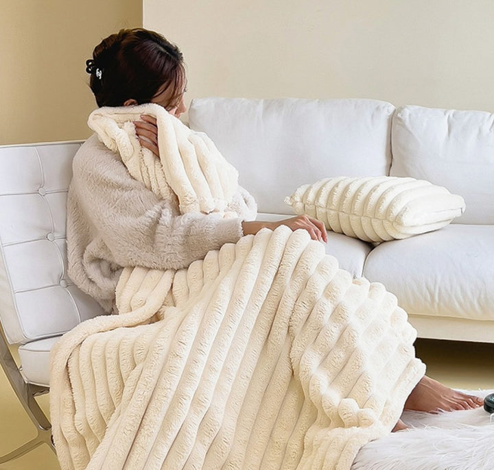 Soft fuzzy throw blanket on a sofa - product photo 1