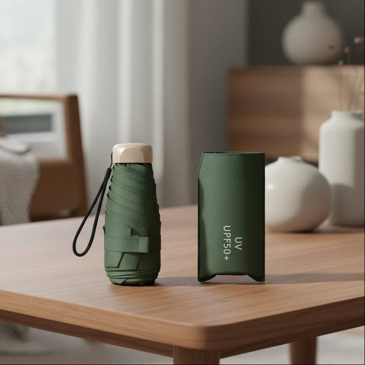 Ultra-compact folding umbrella beside its storage sleeve - product photo 1
