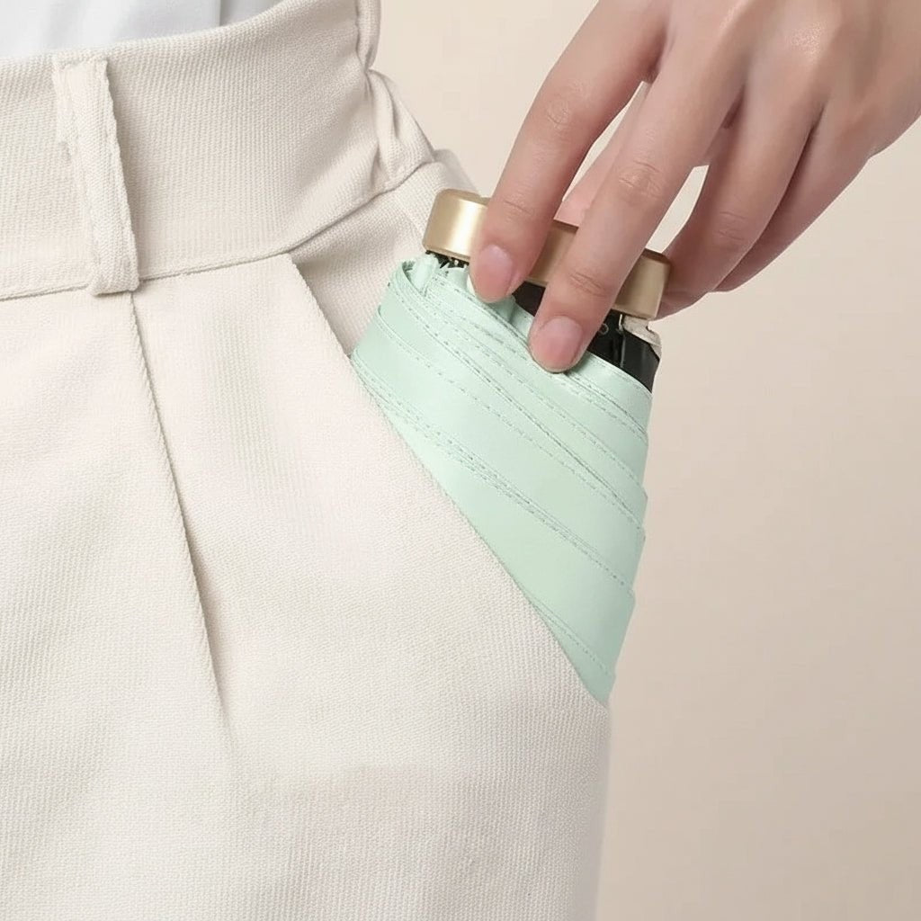 Ultra-compact folding umbrella beside its storage sleeve - product photo 6