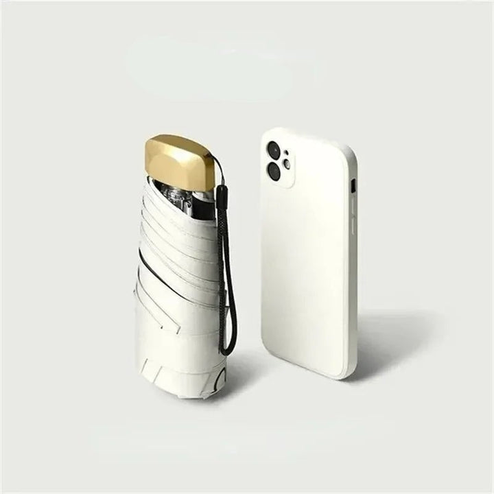 Ultra-compact folding umbrella beside its storage sleeve - product photo 9