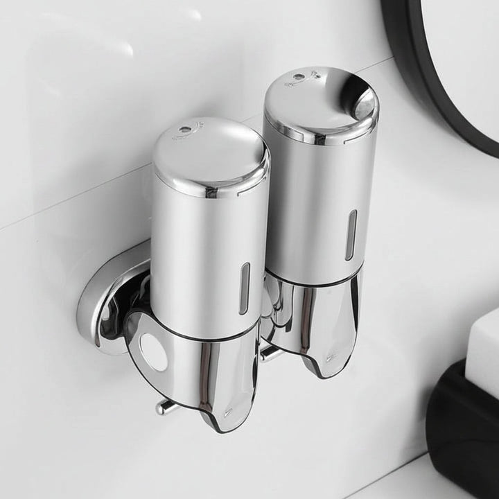 Wall-mounted stainless steel soap dispenser above a basin - product photo 2