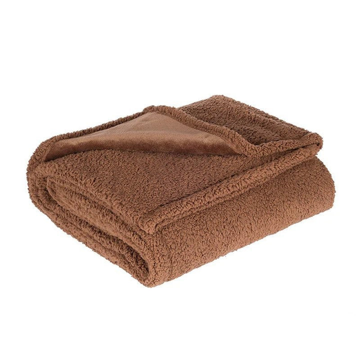 Microfleece throw with a waterproof backing spread over a bed - product photo 5