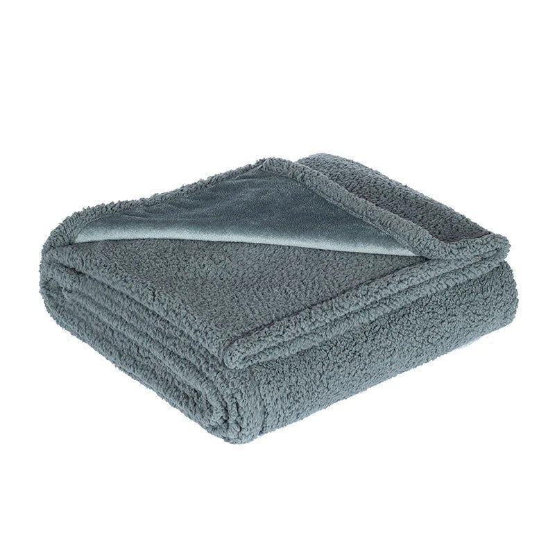 Microfleece throw with a waterproof backing spread over a bed - product photo 6