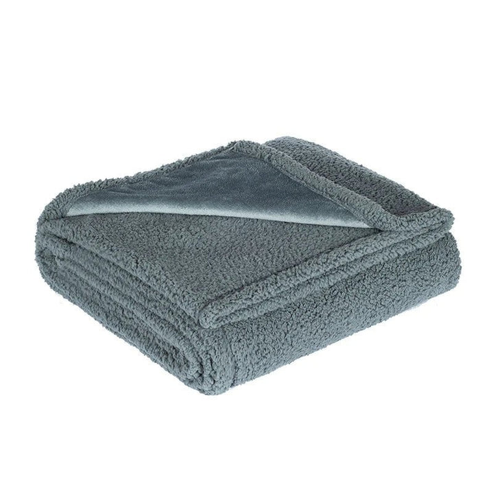 Microfleece throw with a waterproof backing spread over a bed - product photo 6