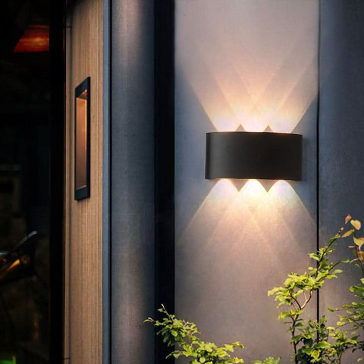 Weatherproof LED outdoor wall light casting an even glow on a wall - product photo 1