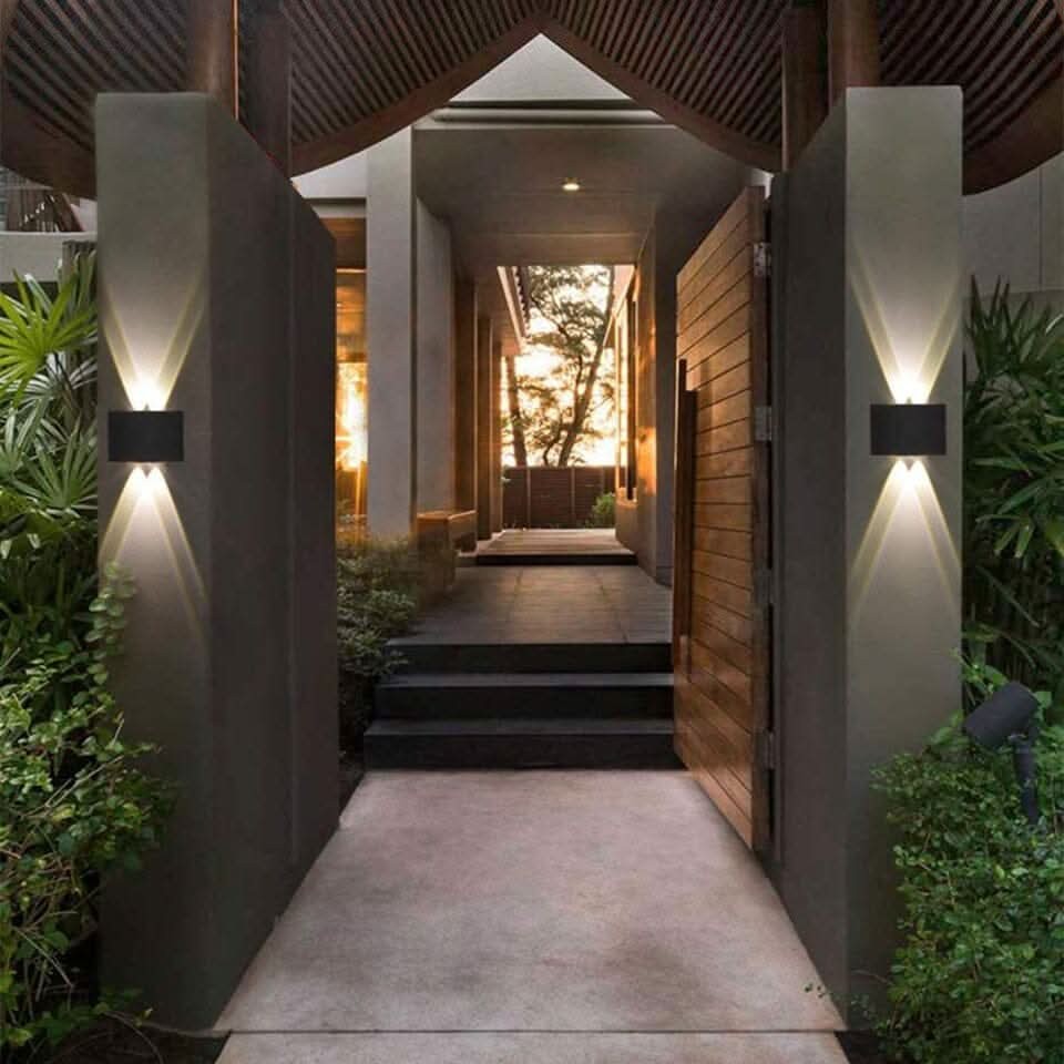 Weatherproof LED outdoor wall light casting an even glow on a wall - product photo 3