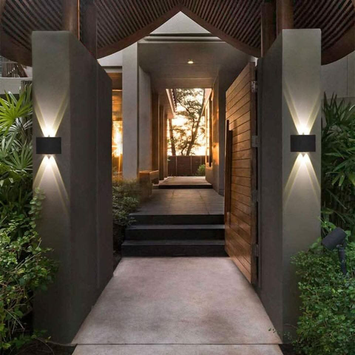 Weatherproof LED outdoor wall light casting an even glow on a wall - product photo 3